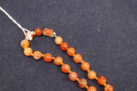 An early 20th century banded agate and other hardstone bead necklace, 80cm.